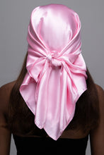 Load image into Gallery viewer, Slender black woman in a black tube top with straight brown hair below her shoulders wearing a light pink, shiny scarf tied in a knot behind her head.
