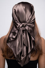 Load image into Gallery viewer, Slender black woman in a black tube top with straight brown hair below her shoulders wearing a shiny, dark brown scarf tied in a knot behind her head.
